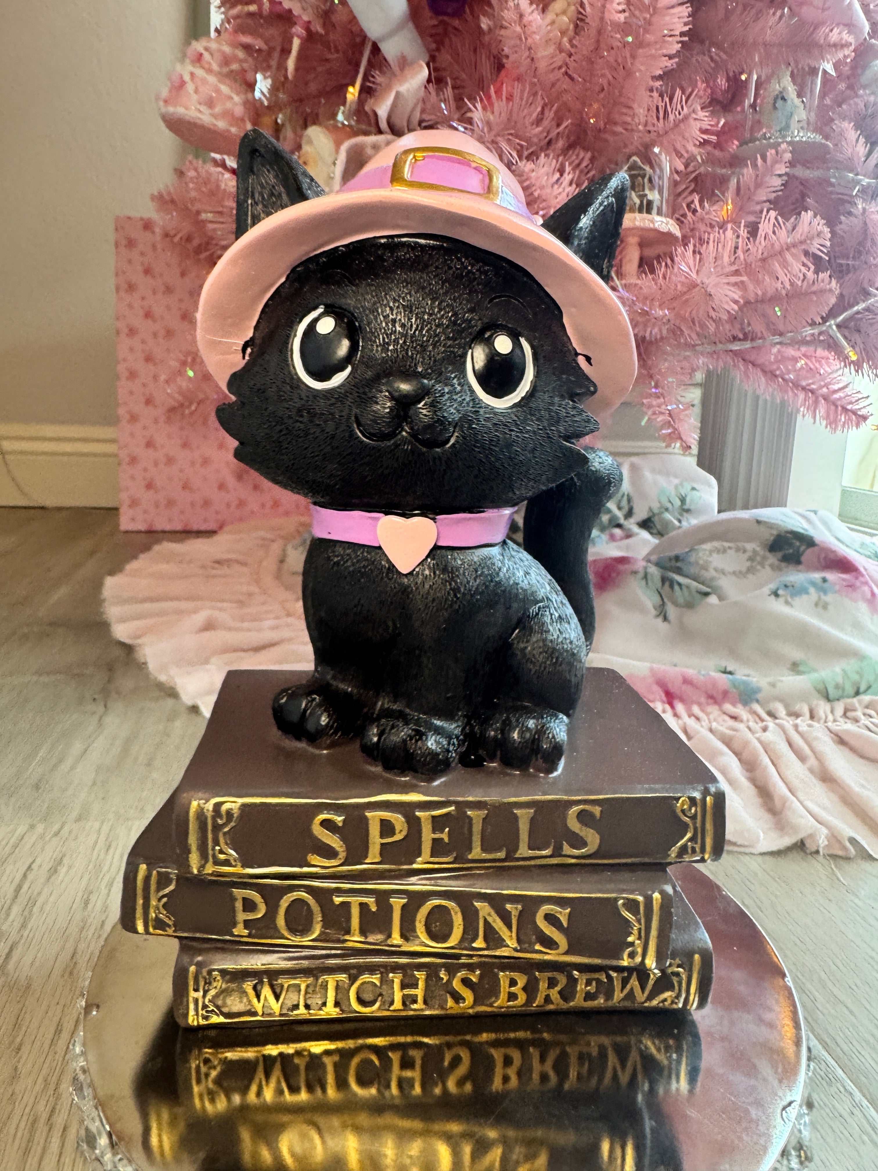 Halloween pink kitty on spell book