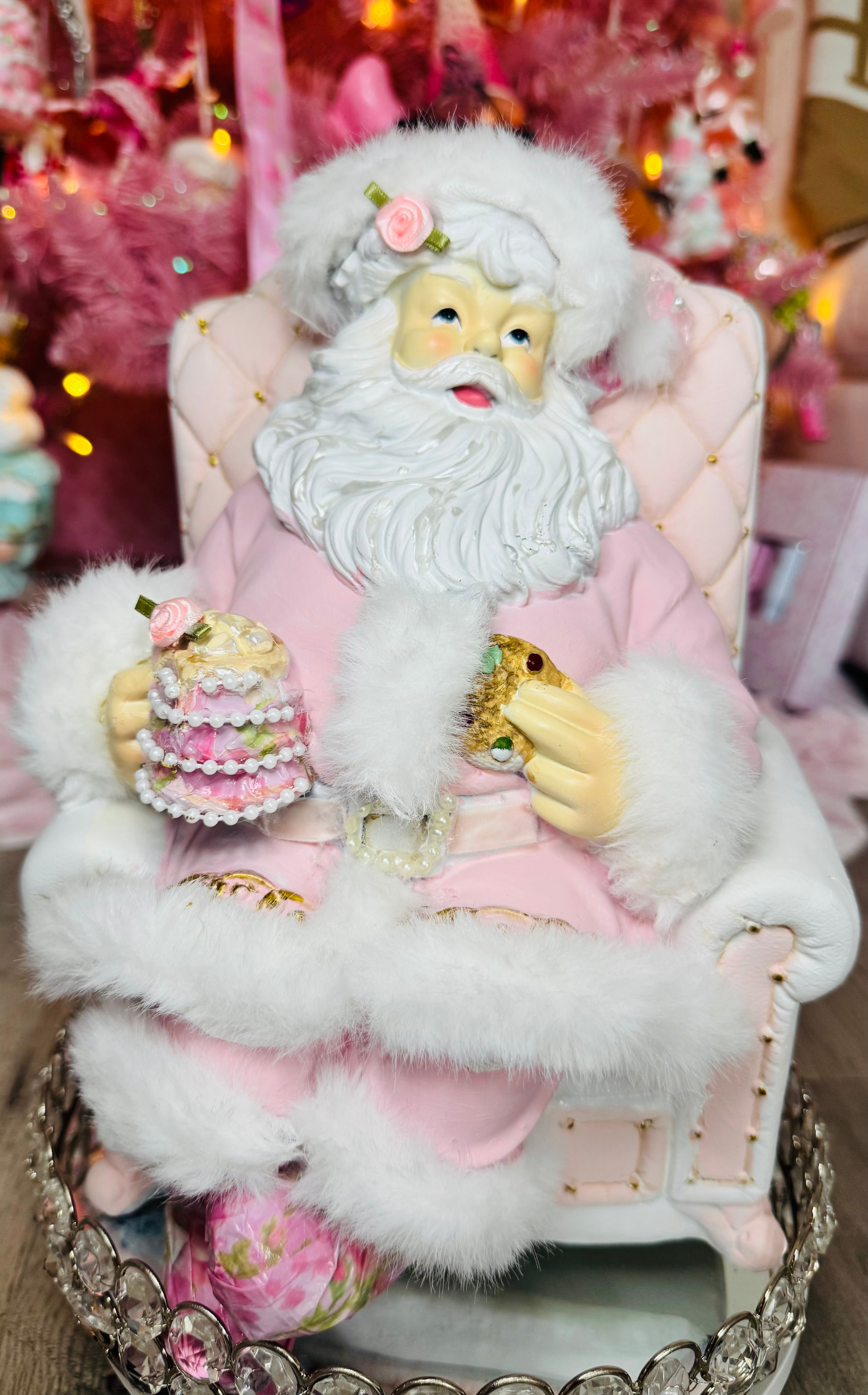 Pink Santa with on recliner figurine